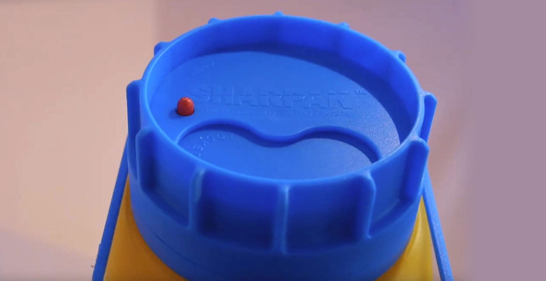 Close-up of a blue Sharpak VisiLOCK lid